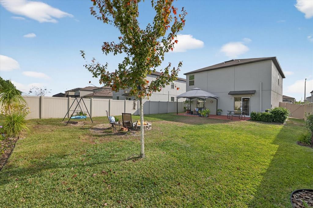 6115 Apple Snail Avenue New Port Richey, FL 34653 - Photo 26 of 59 a house view with a sitting space and garden