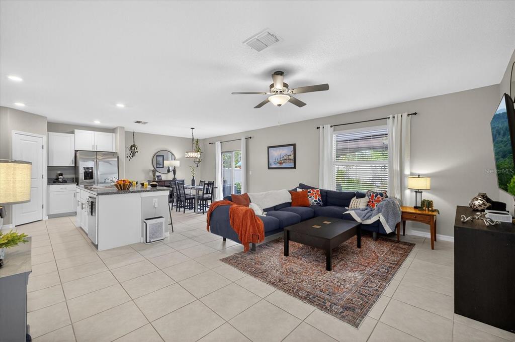 6115 Apple Snail Avenue New Port Richey, FL 34653 - Photo 3 of 59 a living room with furniture and wooden floor