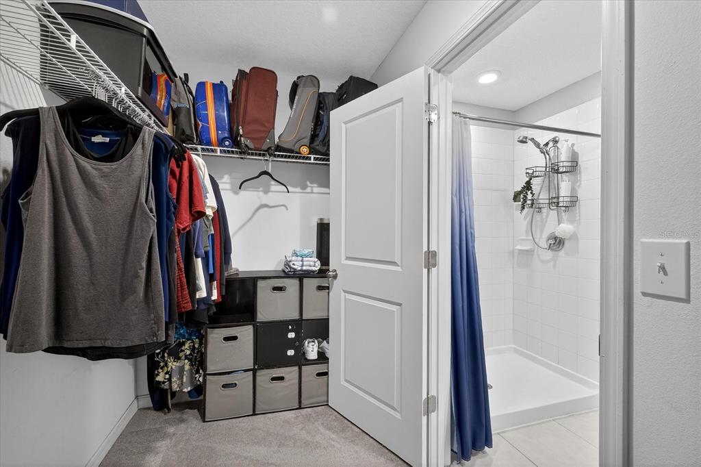 6115 Apple Snail Avenue New Port Richey, FL 34653 - Photo 39 of 59 a view of walk in closet with clothes and shoes