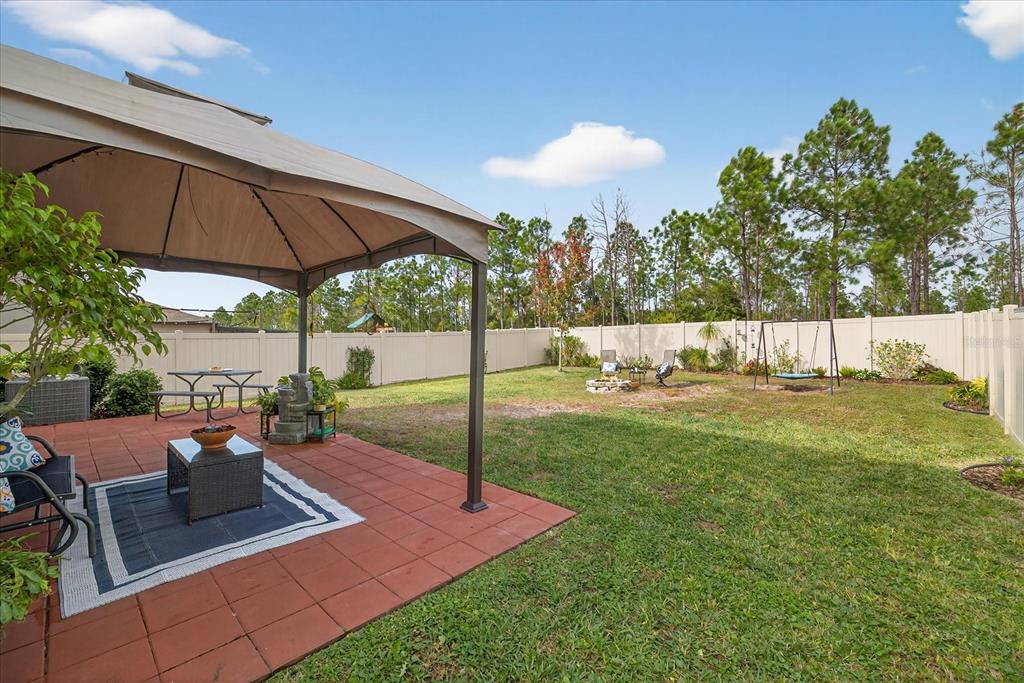 6115 Apple Snail Avenue New Port Richey, FL 34653 - Photo 46 of 59 a view of a backyard with sitting area