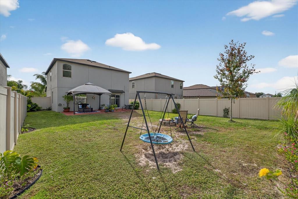 6115 Apple Snail Avenue New Port Richey, FL 34653 - Photo 47 of 59 a swimming pool with table and chairs