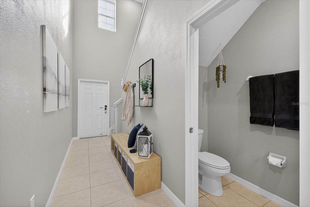 6115 Apple Snail Avenue New Port Richey, FL 34653 - Photo 7 of 59 a bathroom with a toilet a sink and shower