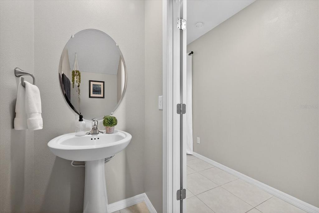 6115 Apple Snail Avenue New Port Richey, FL 34653 - Photo 8 of 59 a bathroom with a sink and a mirror