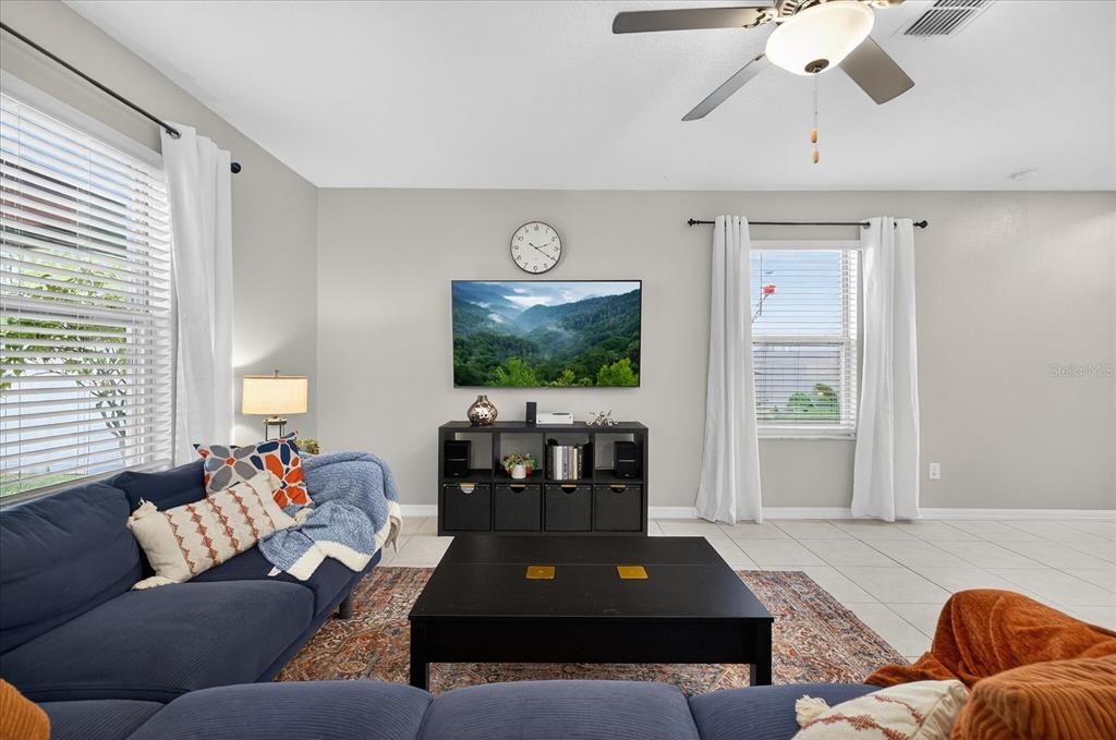 6115 Apple Snail Avenue New Port Richey, FL 34653 - Photo 9 of 59 a living room with furniture and a flat screen tv