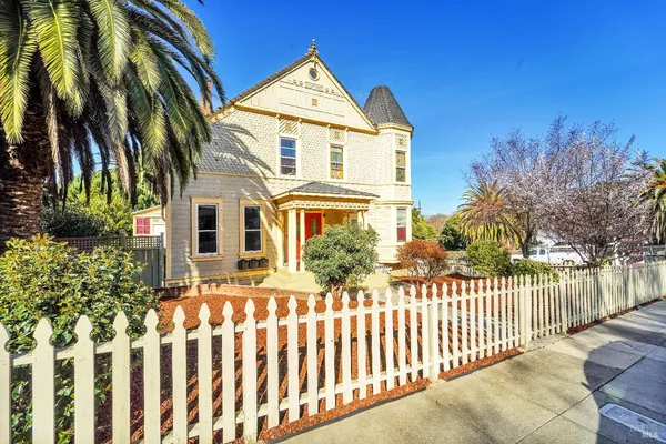 a front view of a house with a garden