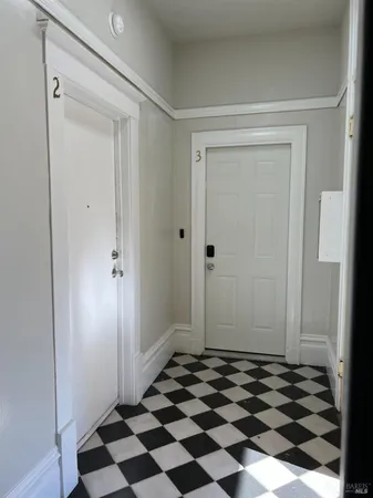 a view of a closet with wooden floor