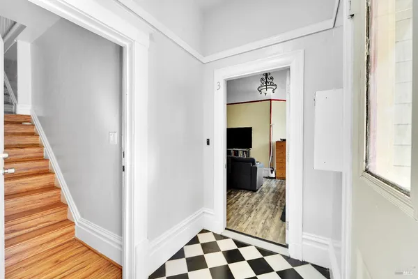 a view of a hallway view with wooden floor and staircase