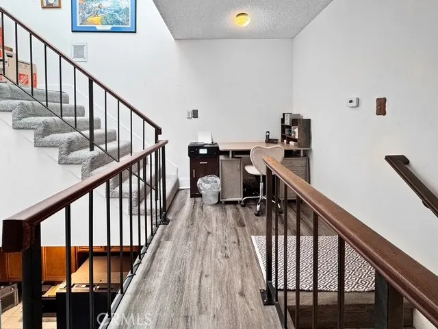 a view of entryway with wooden floor and stairs