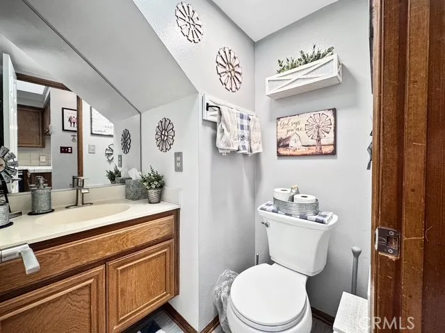 a bathroom with a toilet a sink and mirror