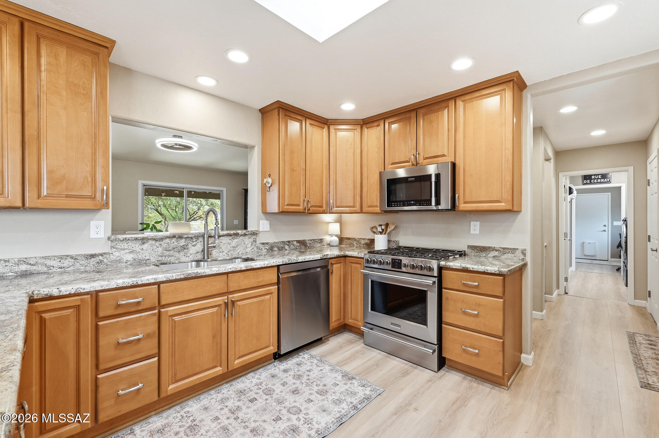 13599 East Rincon Ranch Road Vail, AZ 85641 - Photo 14 of 41 a kitchen with stainless steel appliances granite countertop wooden cabinets and a stove top oven