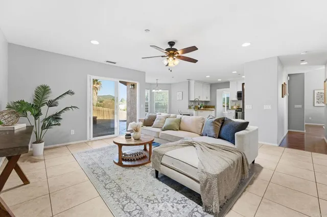 a living room with furniture and a dining table with kitchen view