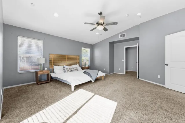 a bathroom with a granite countertop sink a toilet a mirror and shower