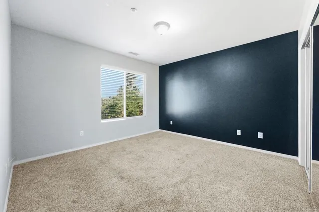 an empty room with windows and closet