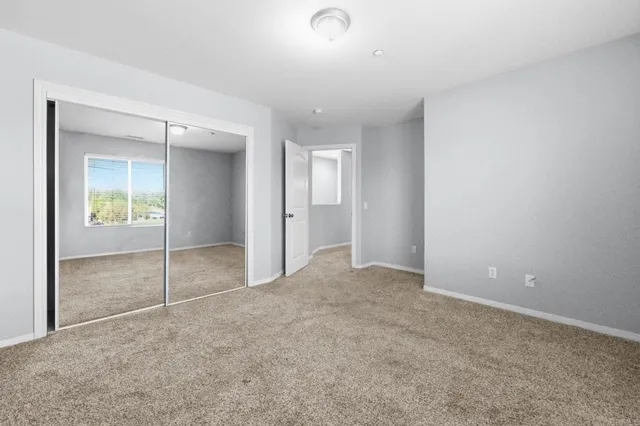 a bathroom with a granite countertop sink toilet a large mirror and shower