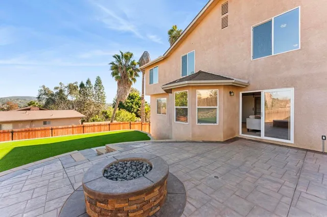 a front view of a house with patio and garden
