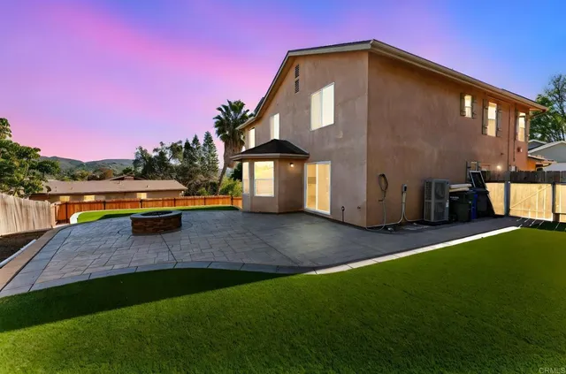 a front view of a house with swimming pool having outdoor seating