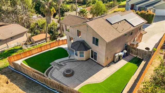 an aerial view of residential houses with outdoor space and river