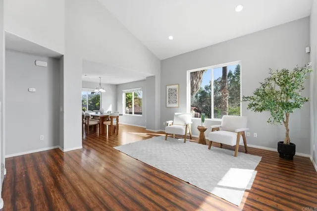 a living room with furniture and large windows
