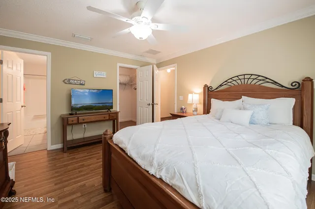 a bedroom with a bed and a television