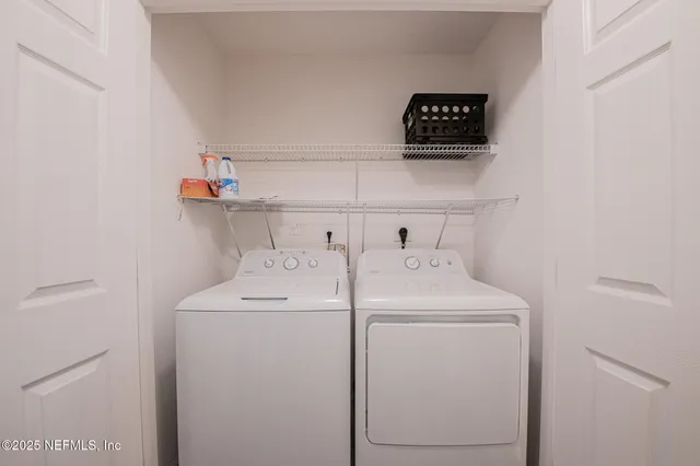 a view of storage and utility room with washer and dryer