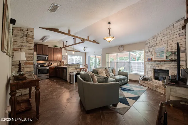 a living room with furniture and a fireplace