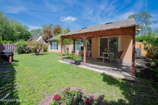 a view of a house with backyard sitting area and garden