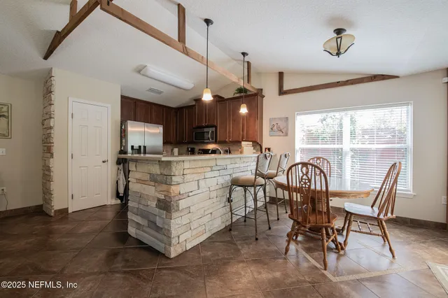 a dining room with furniture and window