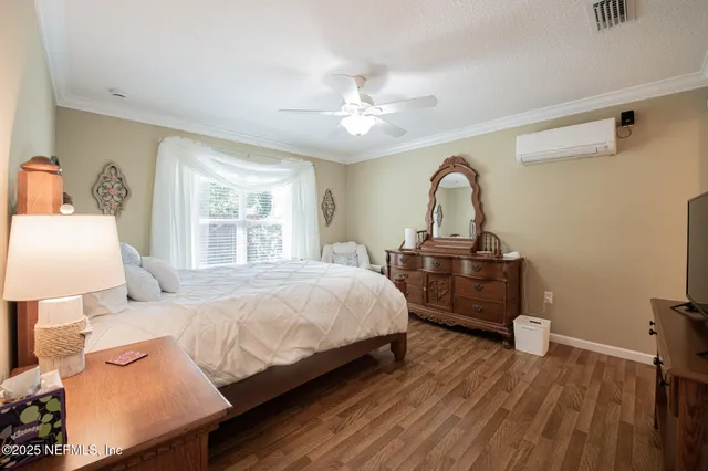a bedroom with a bed and a dresser with mirror