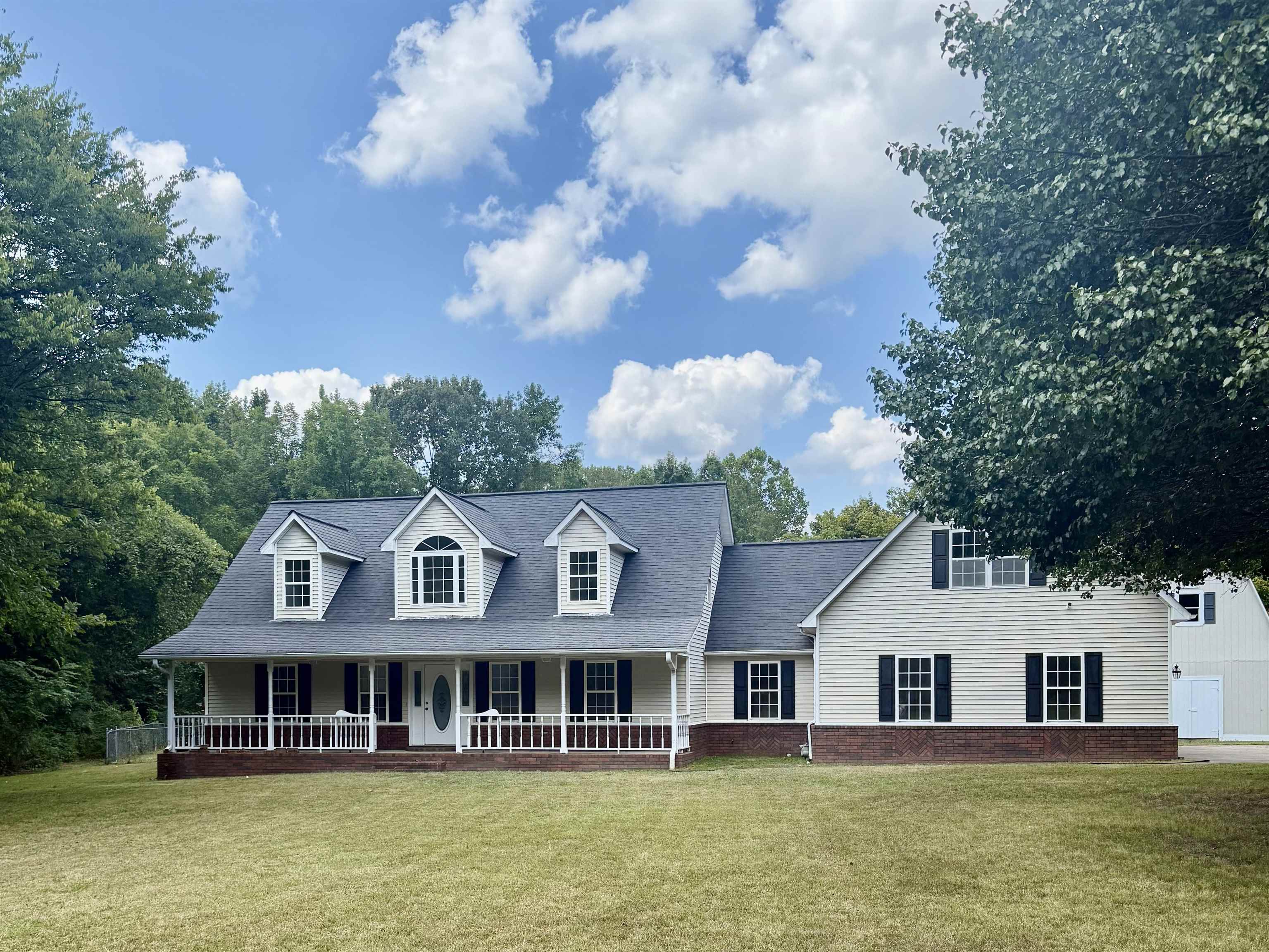 856 Reed Circle Drummonds, TN 38023 - Photo 1 of 24 a front view of a house with swimming pool and trees in the background