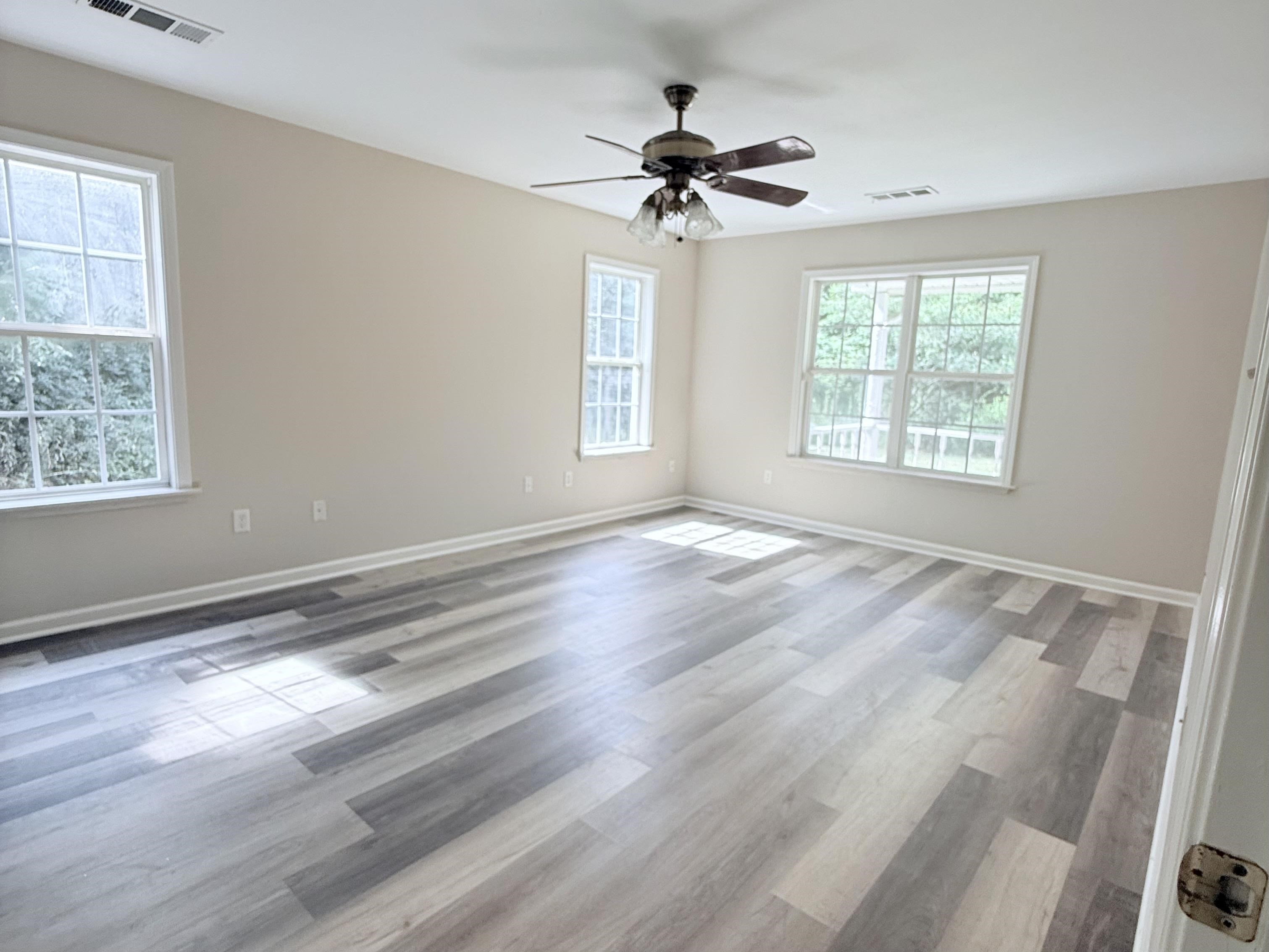 856 Reed Circle Drummonds, TN 38023 - Photo 11 of 24 a view of an empty room with wooden floor and a window