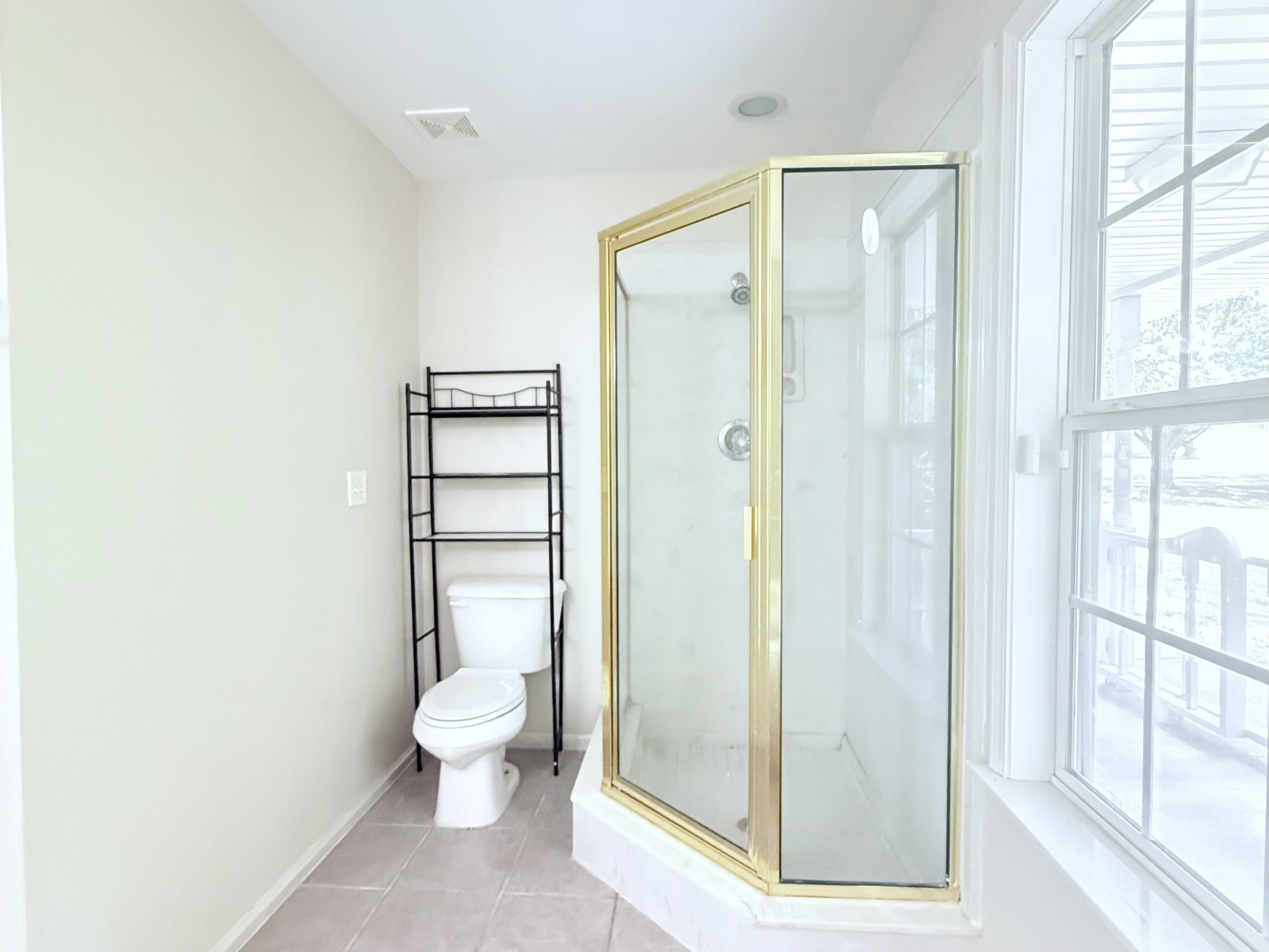 856 Reed Circle Drummonds, TN 38023 - Photo 14 of 24 a bathroom with a glass shower door