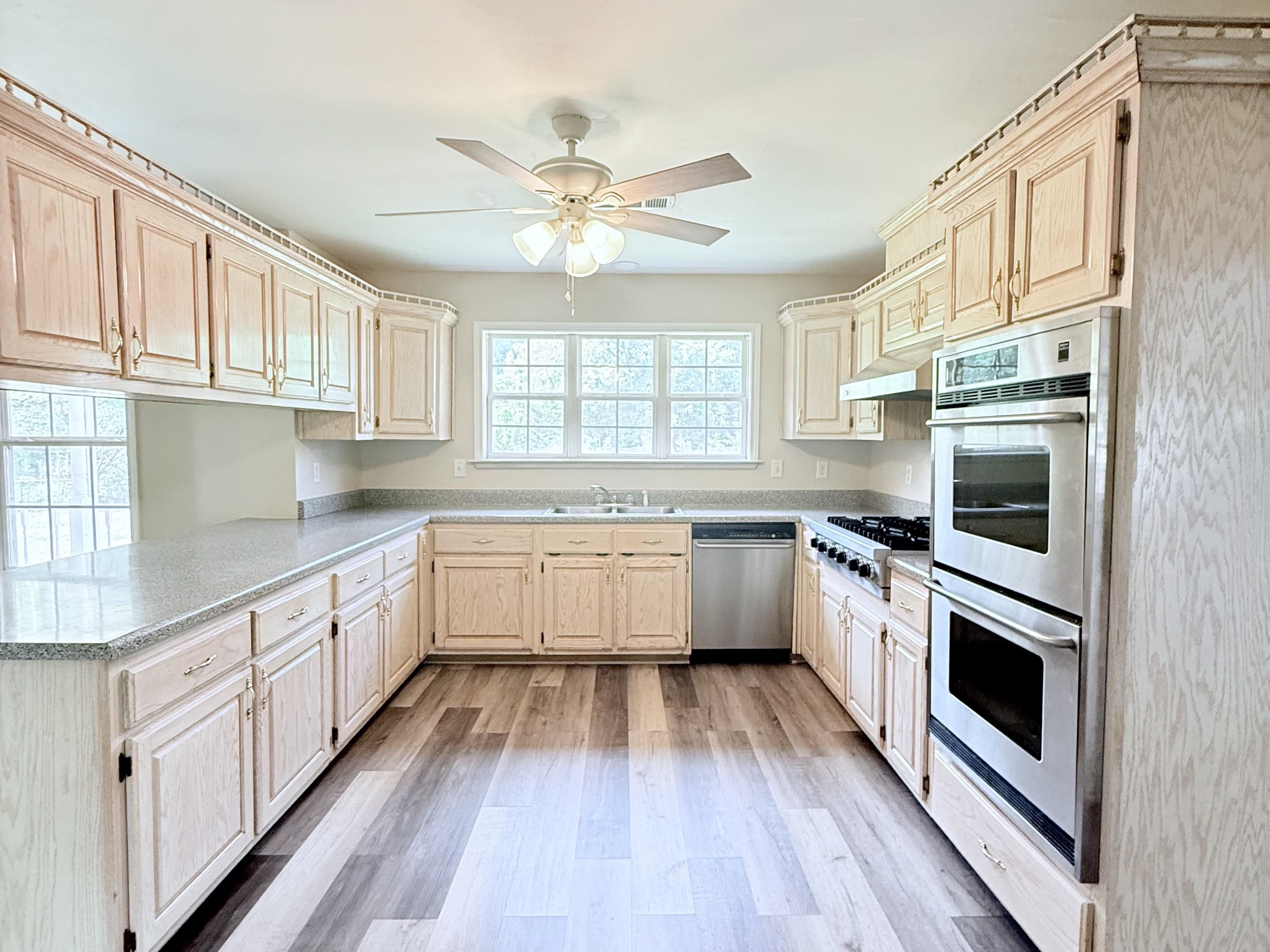 856 Reed Circle Drummonds, TN 38023 - Photo 3 of 24 a kitchen with granite countertop a sink cabinets stainless steel appliances and a window