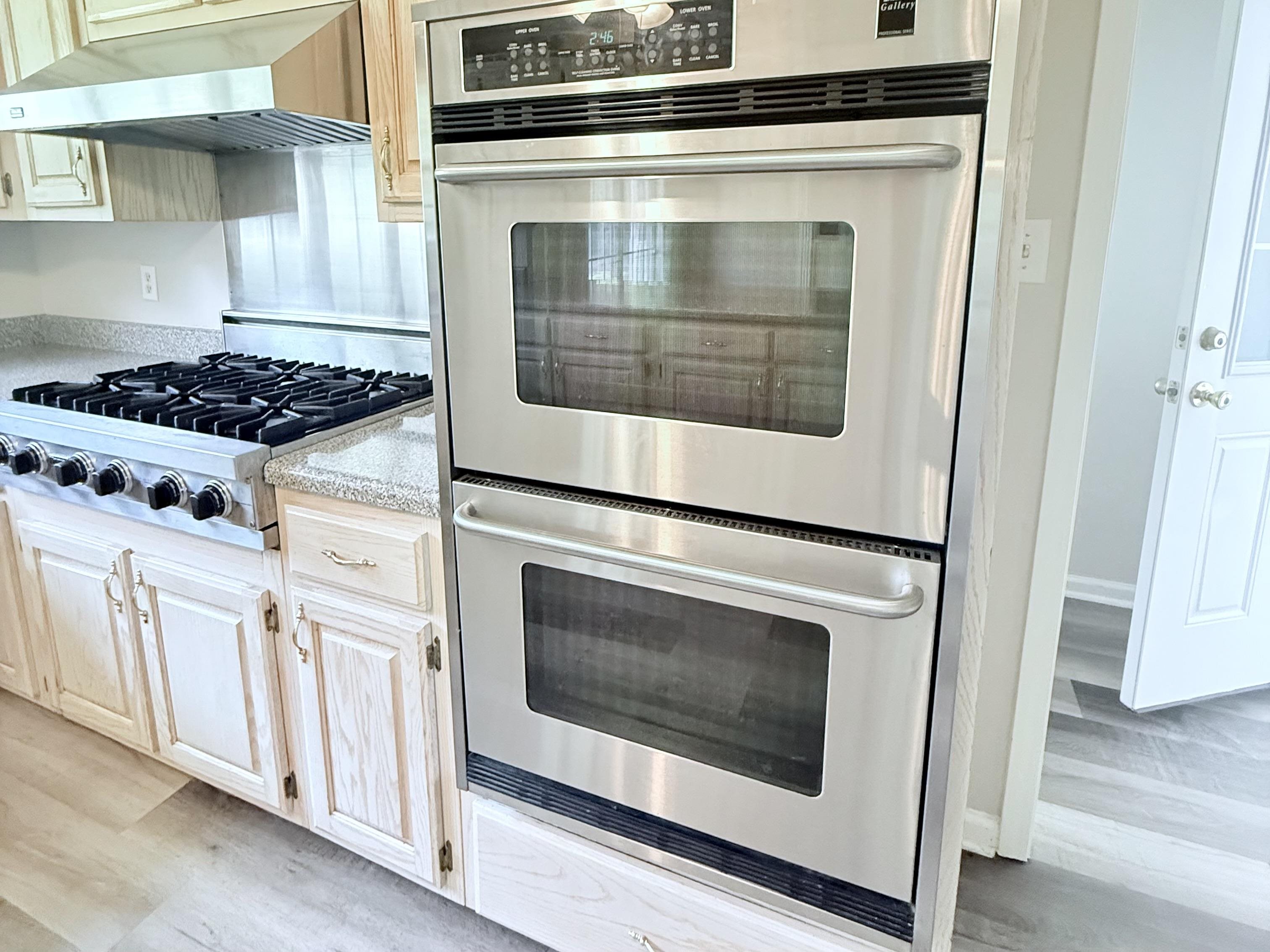 856 Reed Circle Drummonds, TN 38023 - Photo 5 of 24 a kitchen with granite countertop cabinets stainless steel appliances and wooden floor