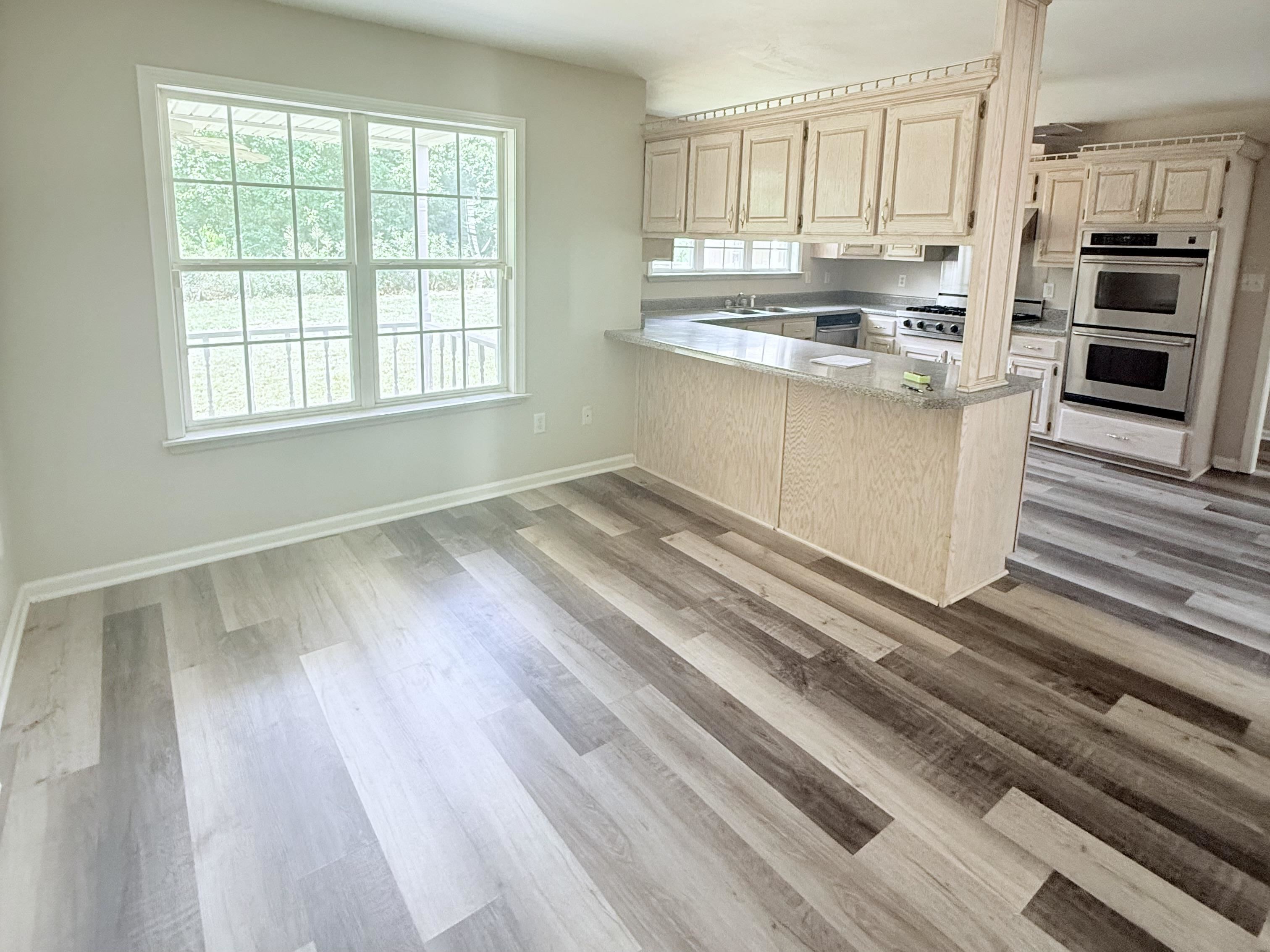 856 Reed Circle Drummonds, TN 38023 - Photo 6 of 24 a kitchen with kitchen island wooden floors and stainless steel appliances