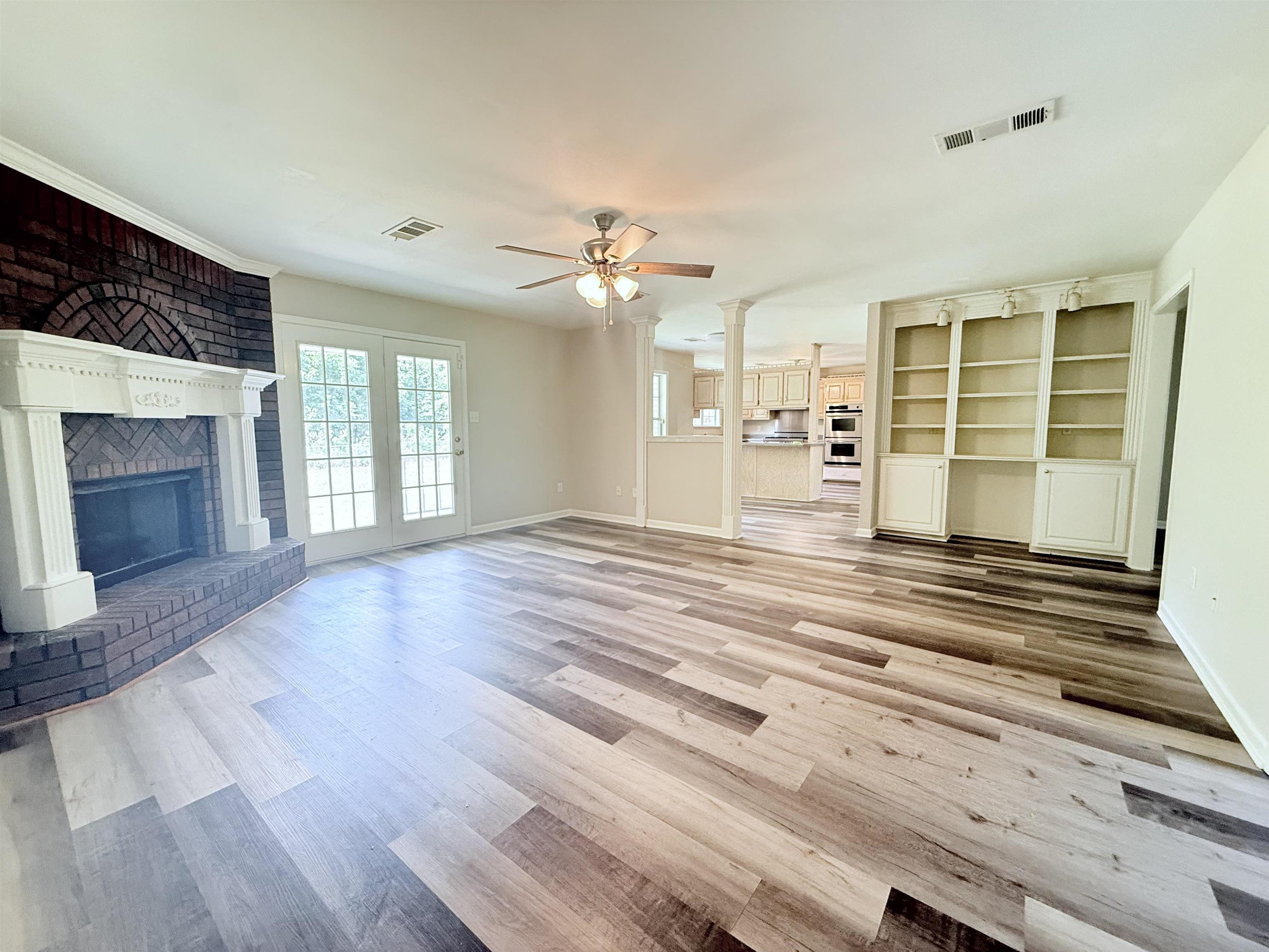 856 Reed Circle Drummonds, TN 38023 - Photo 7 of 24 a view of an empty room with wooden floor and a fireplace