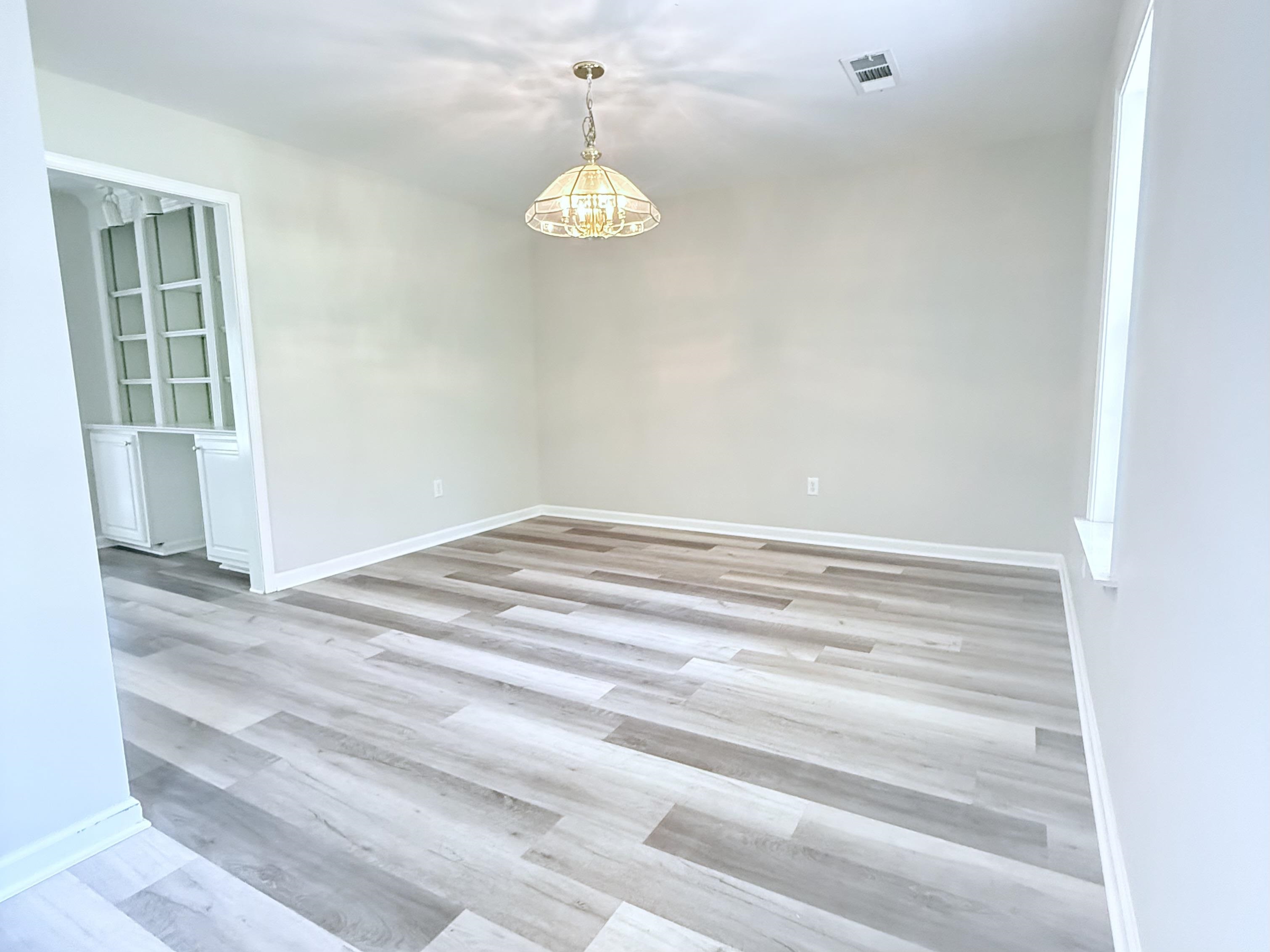 856 Reed Circle Drummonds, TN 38023 - Photo 10 of 24 a view of empty room with wooden floor and fan