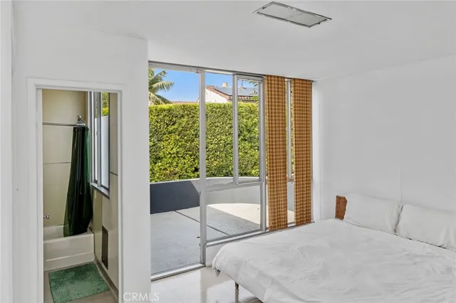 a bed sitting in a bedroom next to a window