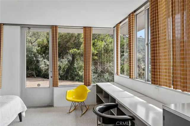 a room with pool table and windows