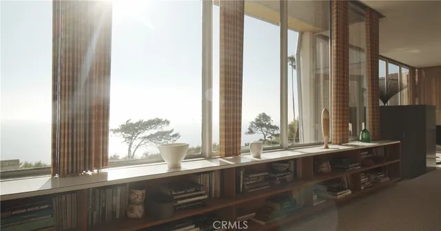 a view of a sink and a large mirror next to a window