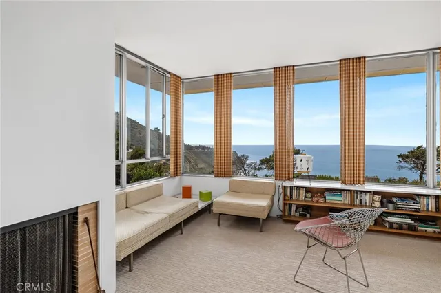 a living room with furniture and a floor to ceiling window