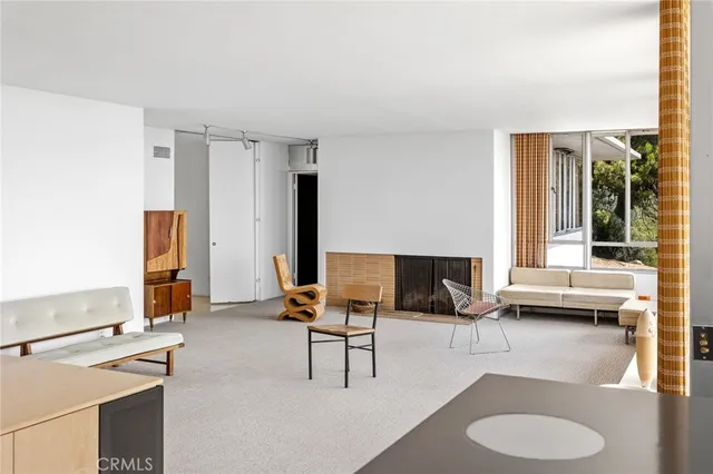 a living room with furniture and large windows