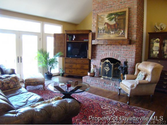4435 Hoffman Road Jackson Springs, NC 27281 - Photo 11 of 25 a living room with furniture large window and a fireplace