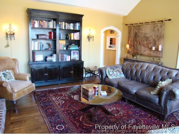 4435 Hoffman Road Jackson Springs, NC 27281 - Photo 12 of 25 a living room with furniture a rug and a bookshelf