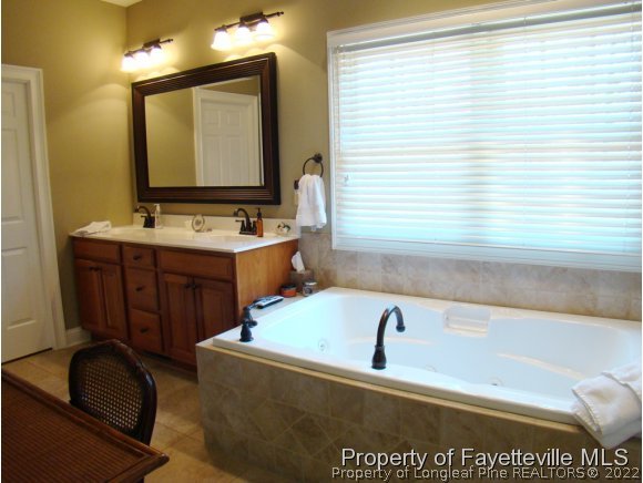 4435 Hoffman Road Jackson Springs, NC 27281 - Photo 15 of 25 a bathroom with a tub sink and mirror