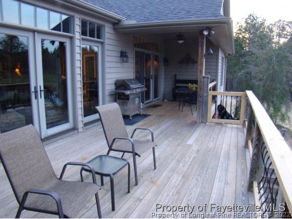 4435 Hoffman Road Jackson Springs, NC 27281 - Photo 19 of 25 a view of a patio with table and chairs with wooden floor and fence