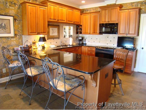 4435 Hoffman Road Jackson Springs, NC 27281 - Photo 4 of 25 a kitchen with a table chairs and a refrigerator