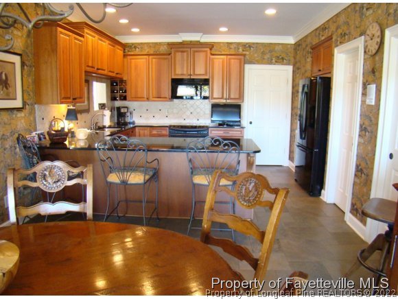 4435 Hoffman Road Jackson Springs, NC 27281 - Photo 5 of 25 a kitchen with stainless steel appliances granite countertop a refrigerator and a stove