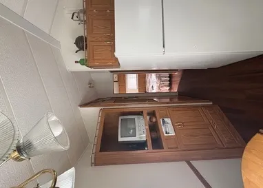 a view of kitchen with stainless steel appliances granite countertop cabinets and stove top oven
