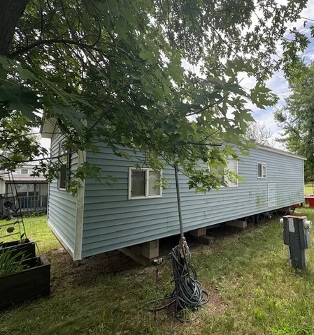 a view of a backyard with chairs and a table