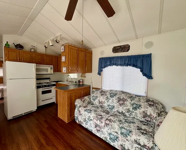 a kitchen with stainless steel appliances kitchen island granite countertop a stove and a refrigerator
